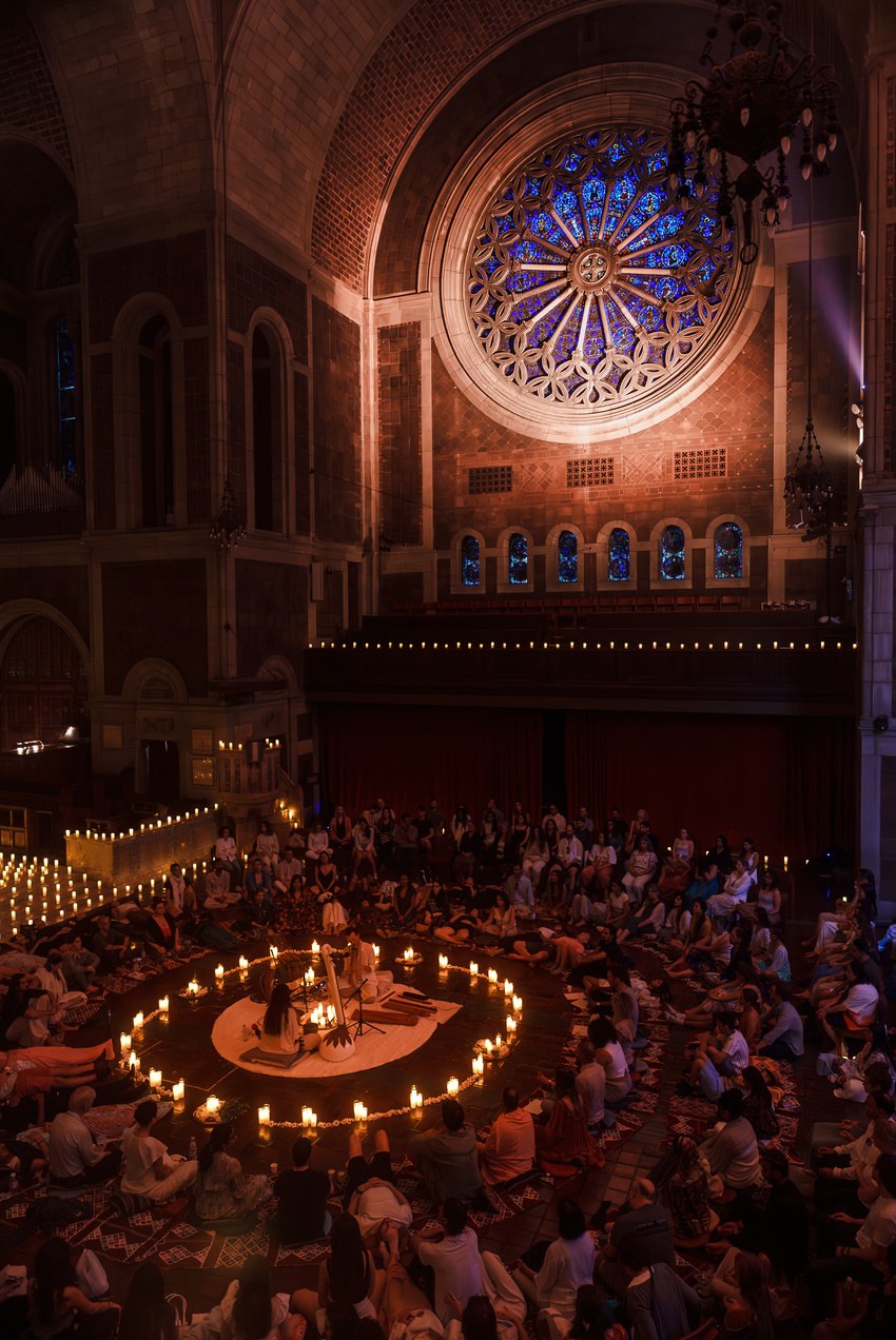 A Nākaloka candlelit gathering in a grand hall